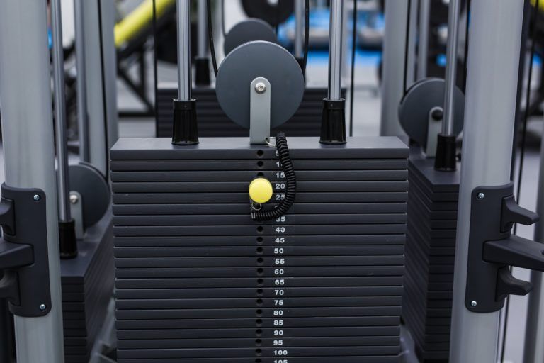 black iron heavy plates stacked of weight machine PZT8TKT 3 768x512