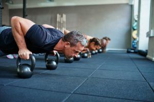 fit people doing pushups on weights in a gym U67HKWM 1 300x200
