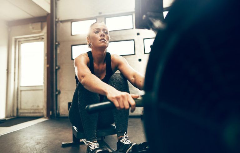 fit young woman exercising on a gym rowing GLT3UW6 1 768x488