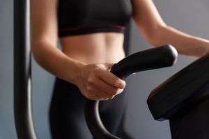 woman exercise elliptical cardio running workout K68SZTB 2 300x200