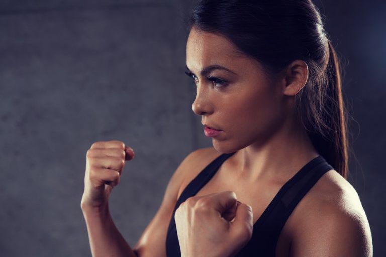 woman holding fists and fighting in gym PR6KQU8 1 768x512