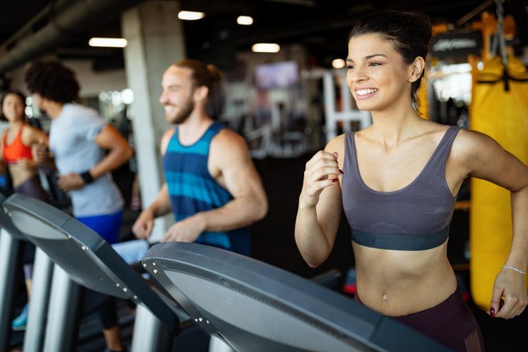 young people running on a treadmill in modern gym SZD57JX 2 768x512