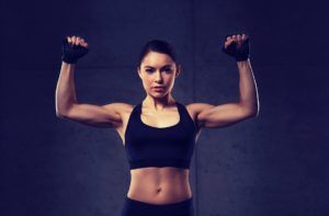 young woman flexing muscles in gym PL8W9H8 2 300x197