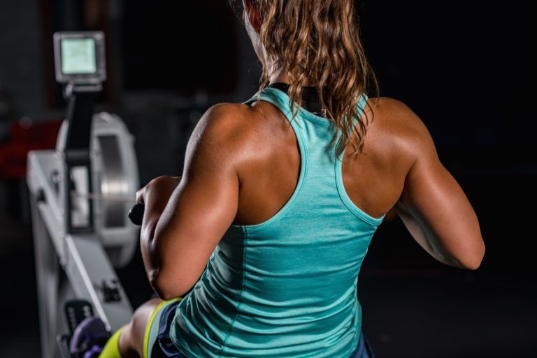 woman athlete exercising on rowing machine PP5TT75 768x513
